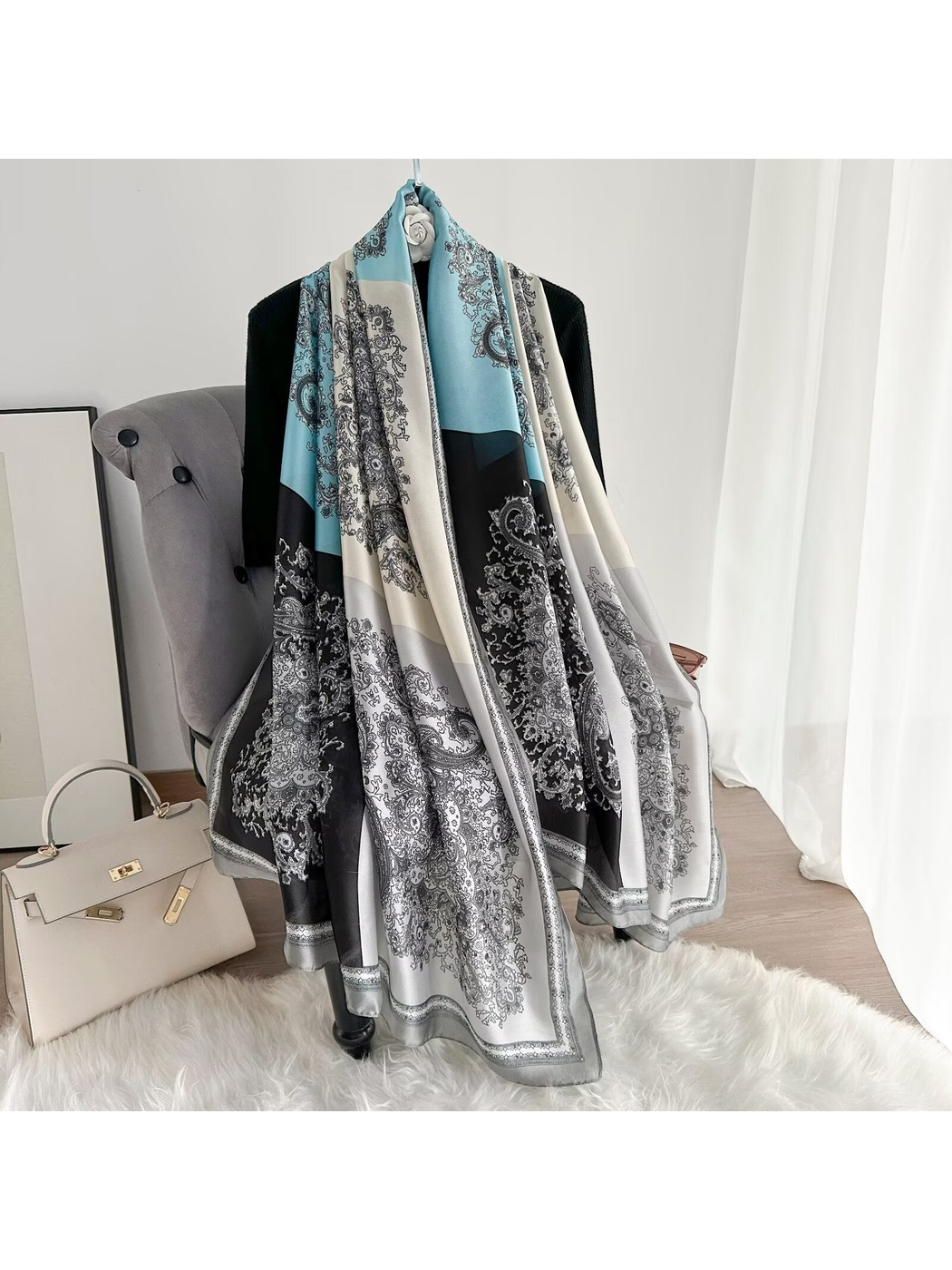 Light blue, ivory and black color-block paisley scarf draped at full length