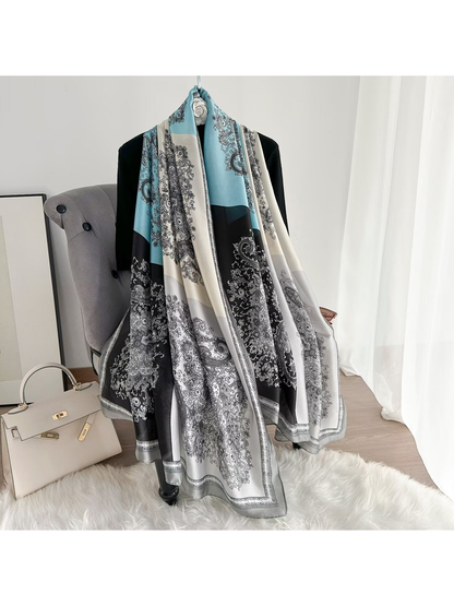 Light blue, ivory and black color-block paisley scarf draped at full length