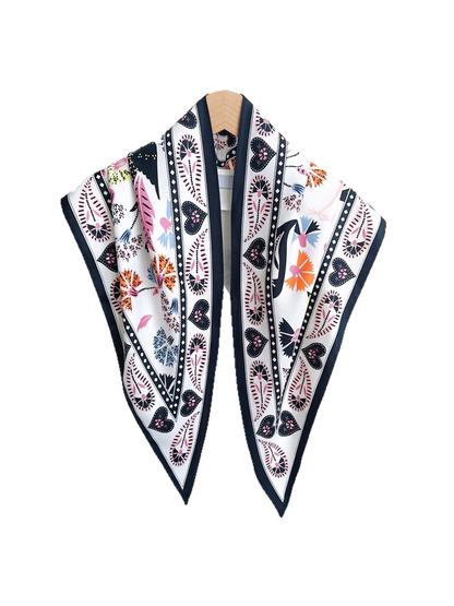 White triangle scarf with navy border and colorful floral and heart motifs