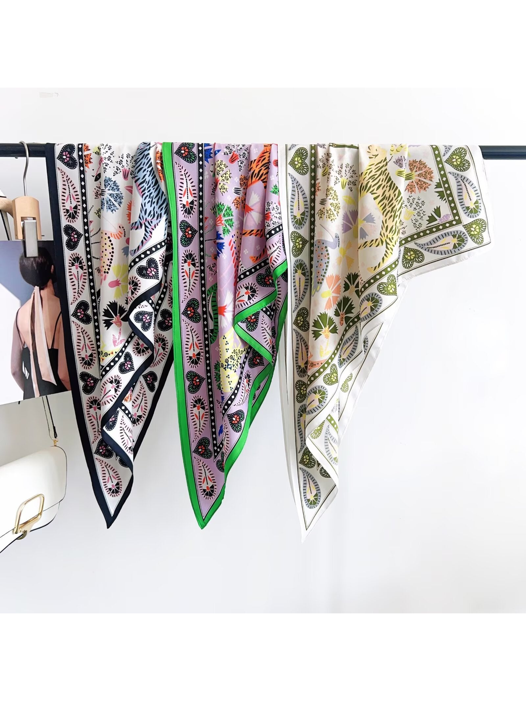 Three floral and heart motif triangle scarves displayed together