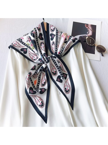 White and navy triangle scarf knotted over a white blouse