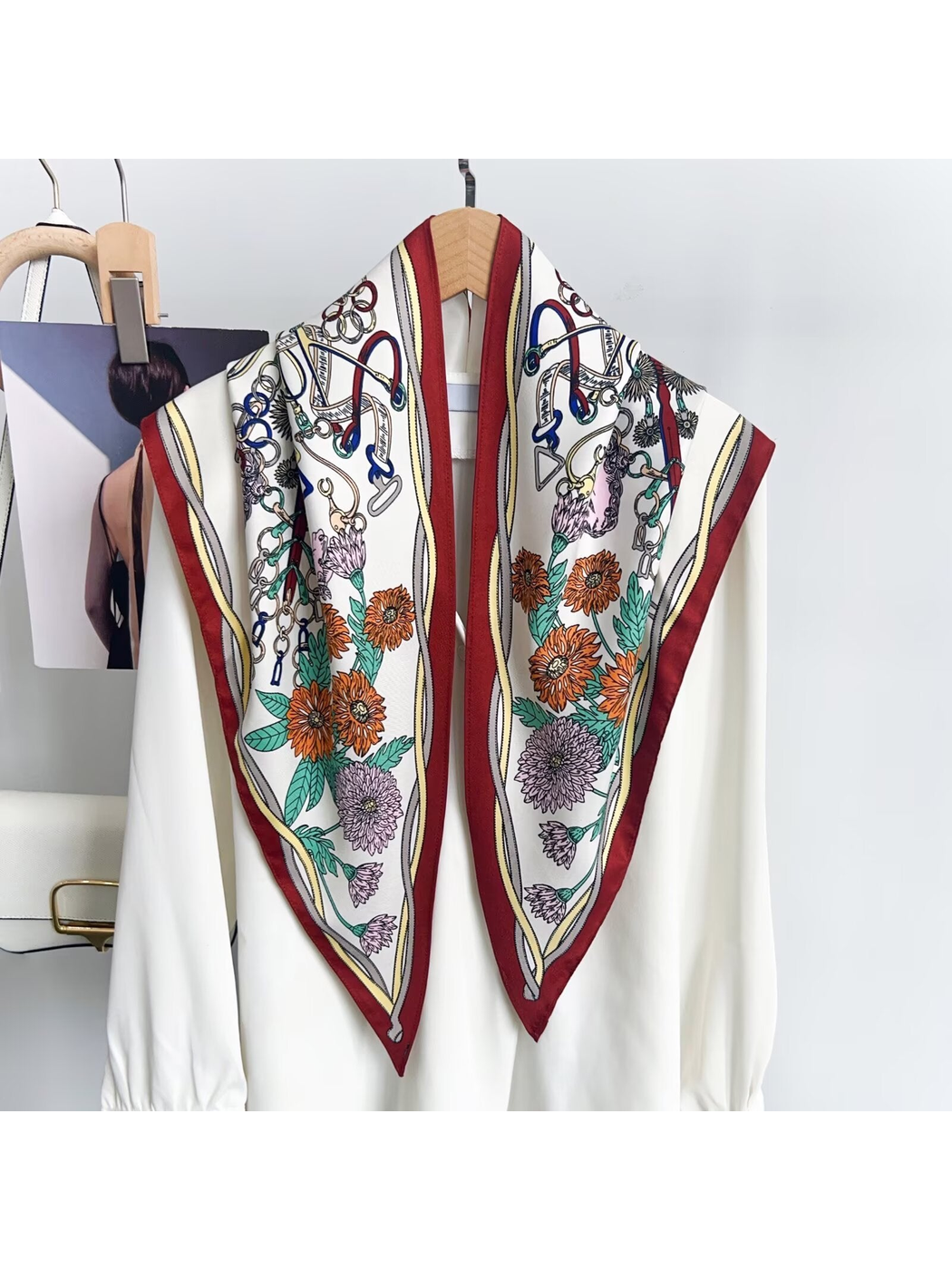 Burgundy-border triangle scarf draped over a white blouse to show the floral and equestrian print