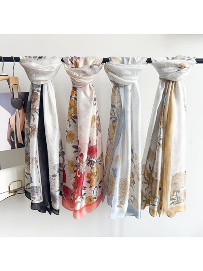 Floral scarves in Multicolor, Black Gray, Gold, and Light Blue displayed on a rack