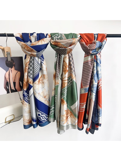Blue, green and orange floral long rectangular scarves displayed together