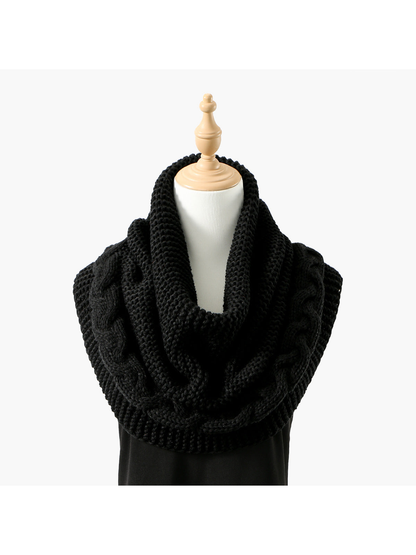 Black knit infinity scarf with braided cable border, draped front view