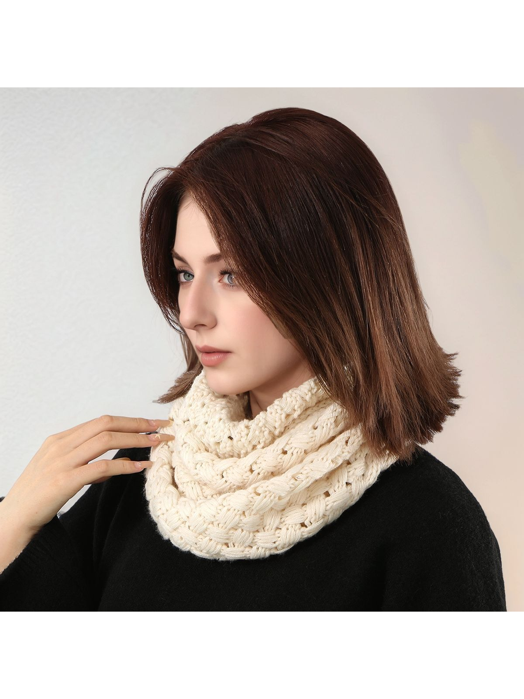 Cream basket-pattern infinity scarf worn closely looped around the neck