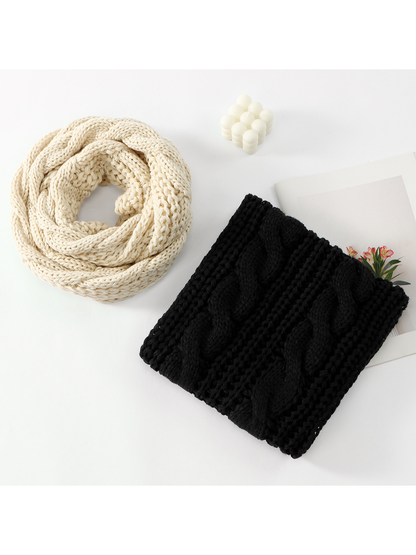 Cream and black cable-pattern infinity scarves displayed together