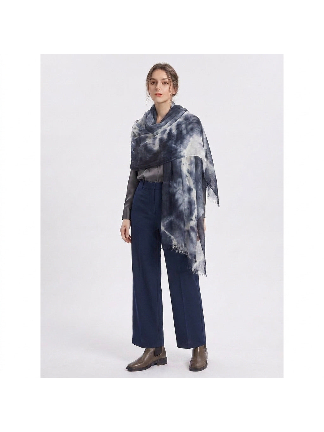 Dark blue and white tie-dye scarf draped around the shoulders over a gray outfit