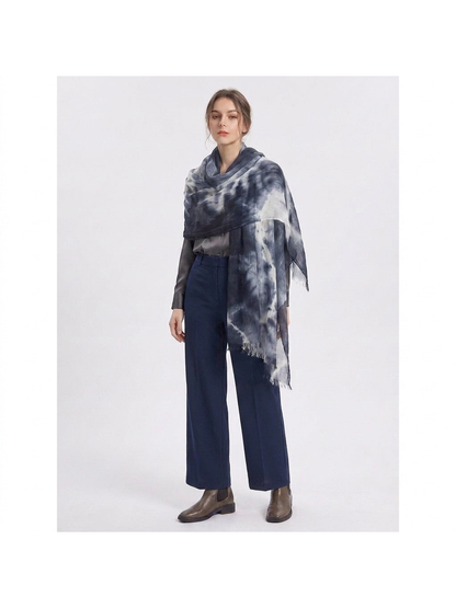 Dark blue and white tie-dye scarf draped around the shoulders over a gray outfit
