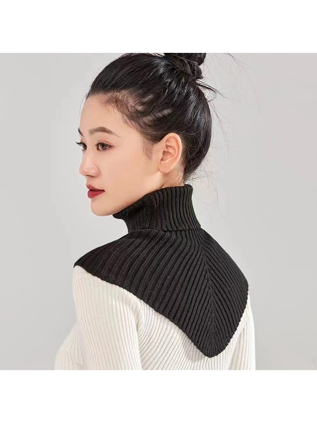 Black ribbed turtleneck bib collar worn from the back and side