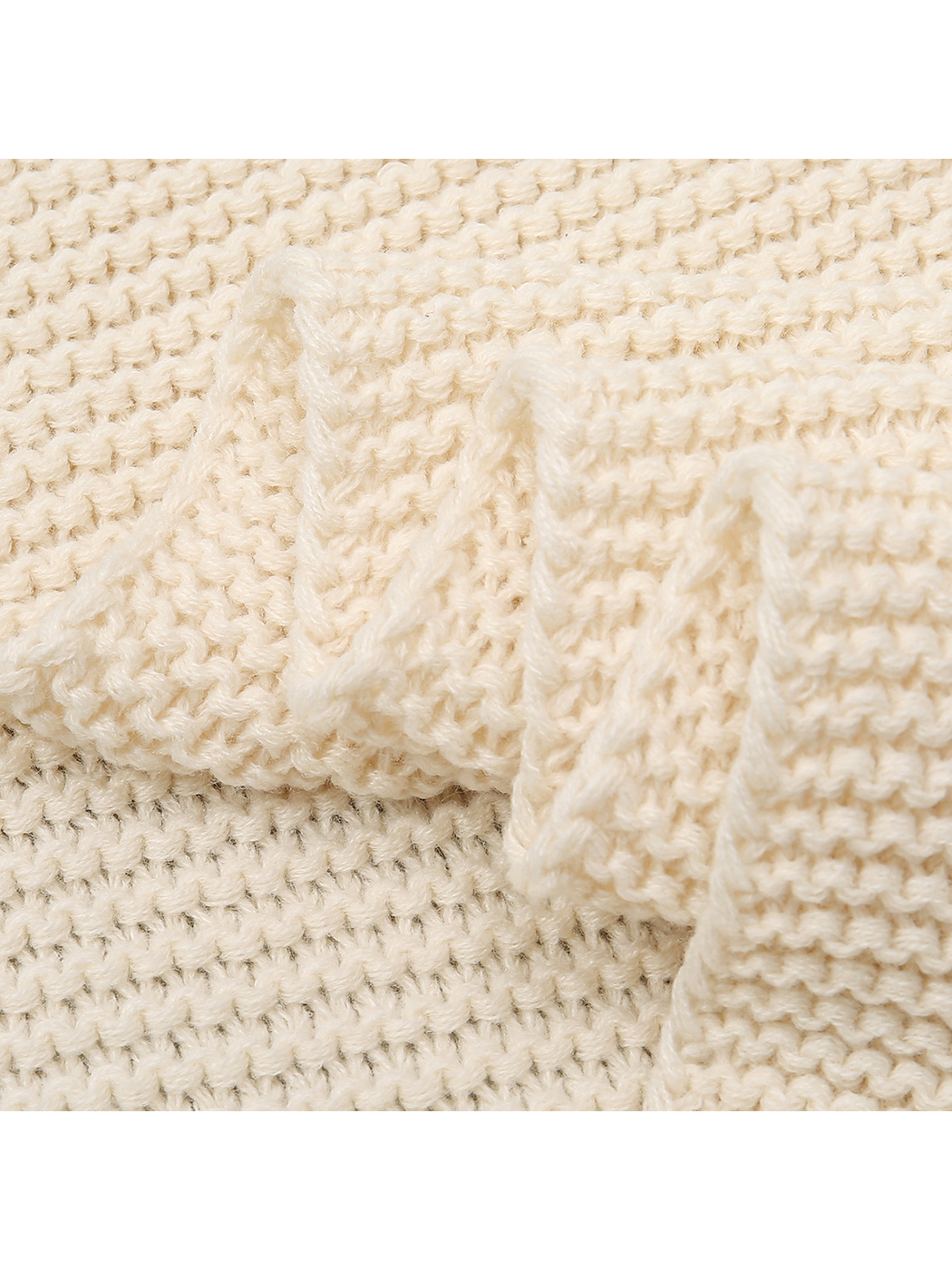 Close-up of the Beige scarf's textured knit and finished edge