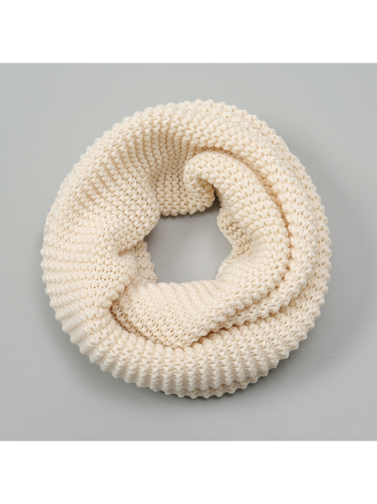 Beige chunky knit infinity scarf arranged in a circular loop