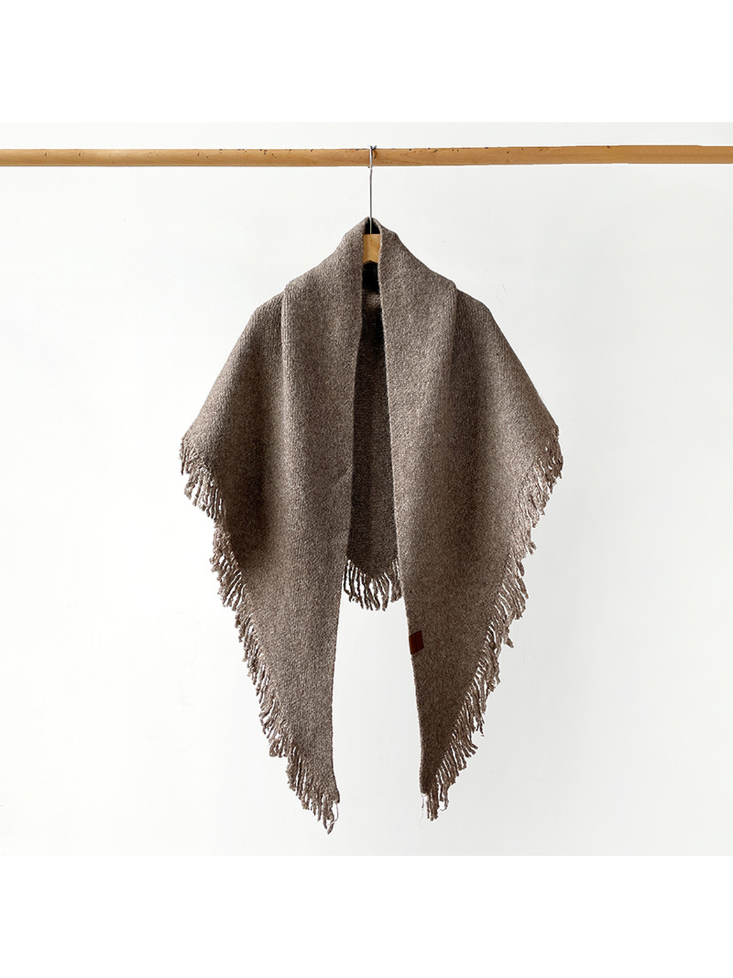 Brown fringed scarf hanging open to show its full drape