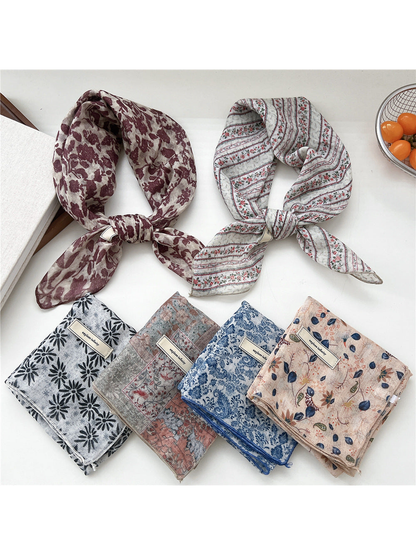 Floral square scarves displayed in tied and folded arrangements