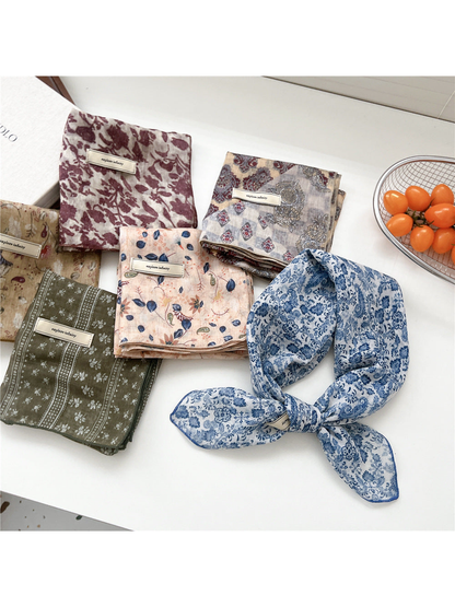 Blue floral square scarf tied beside assorted folded patterns