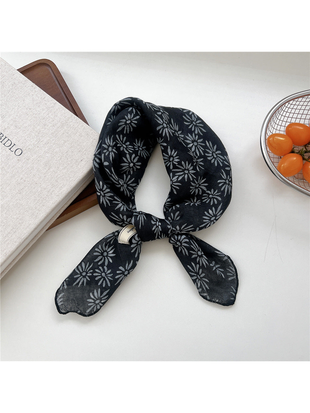Black Daisy square scarf tied in a loop