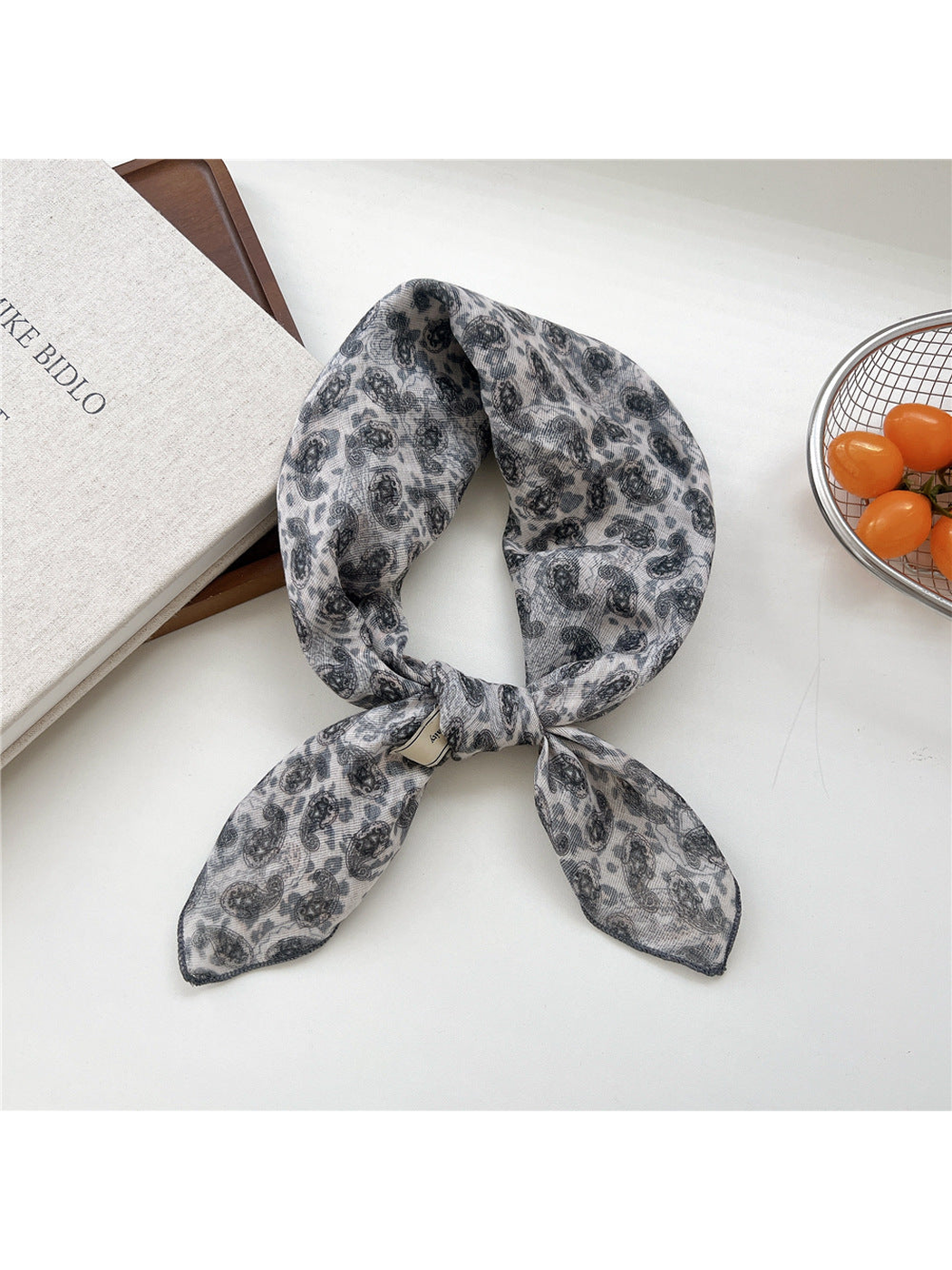 Animal Paisley square scarf tied in a loop