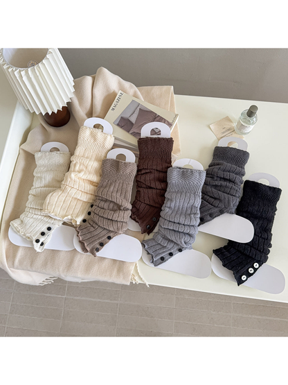 Seven ribbed leg-warmer colorways with split button-trimmed lower edges.