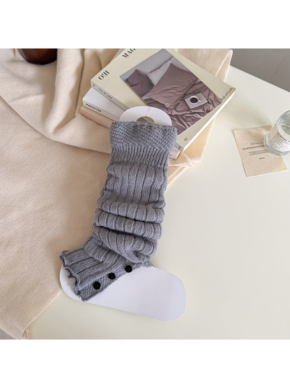 Light gray ribbed leg warmer with a textured cuff and black button trim.