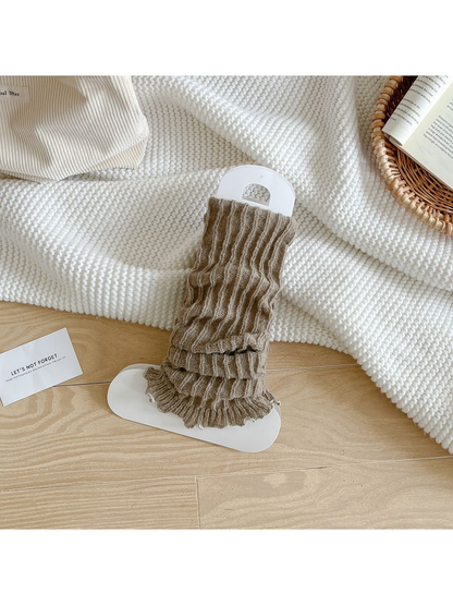 Greige ribbed leg warmers with a ruffled edge