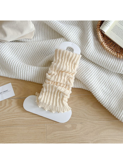 Cream ribbed leg warmers with a ruffled edge