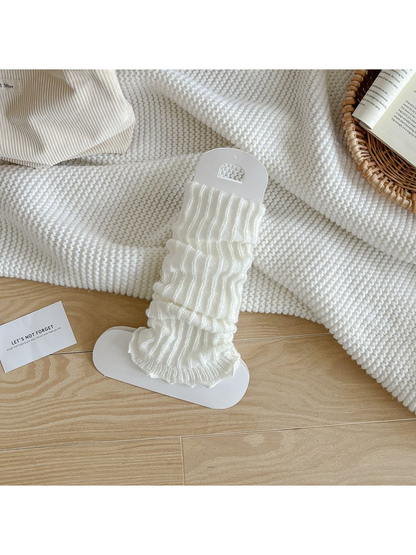 White ribbed leg warmers with a ruffled edge