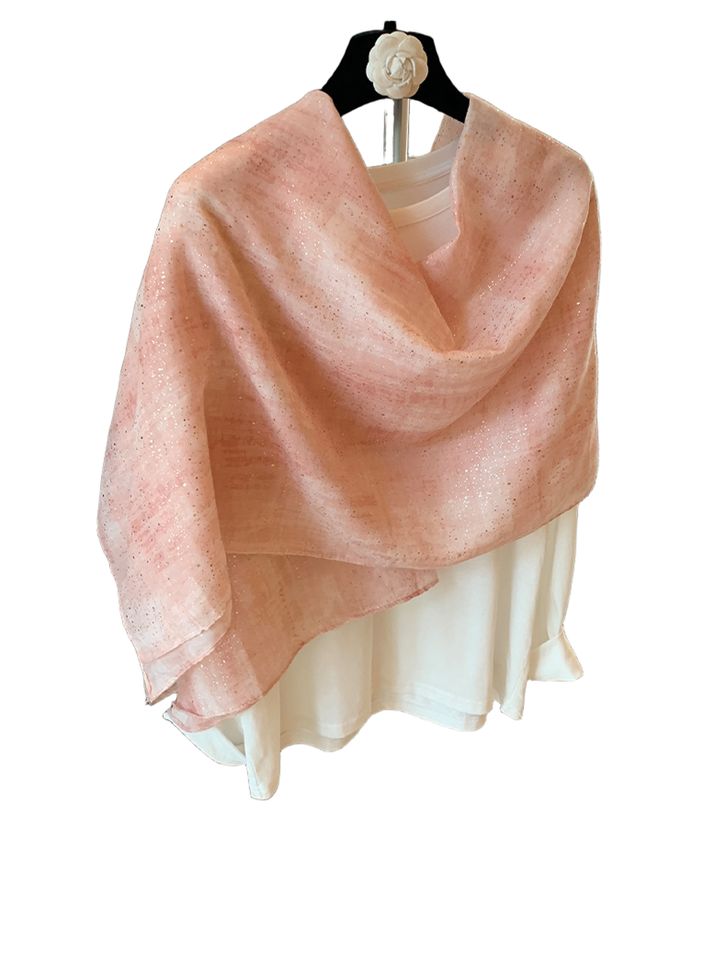 Pink scarf with metallic-look flecks arranged in a loose shoulder drape
