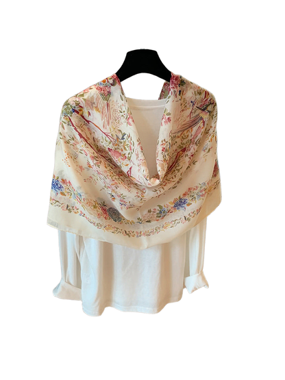 Ivory floral and bird print scarf arranged in a looped drape