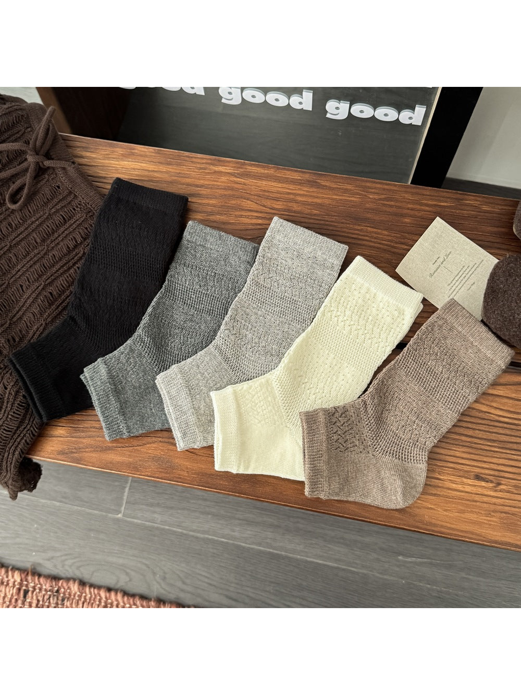 Black, gray, cream and khaki open-toe socks displayed together