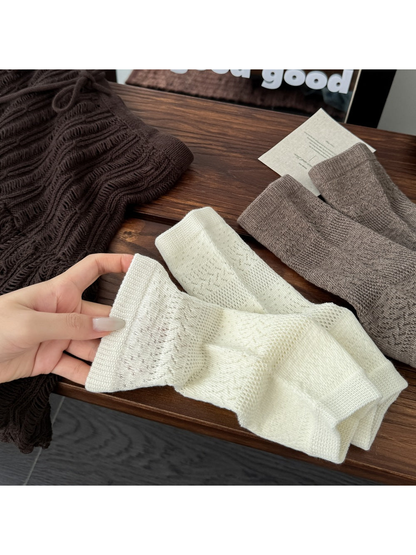Cream and khaki open-toe socks with pointelle knit patterns