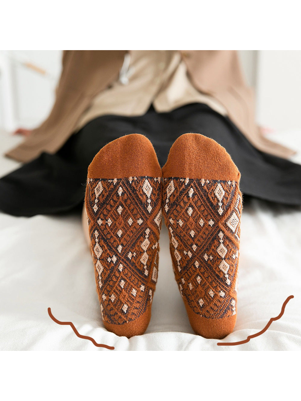 Close-up of orange diamond-pattern socks showing the soles and contrasting toes
