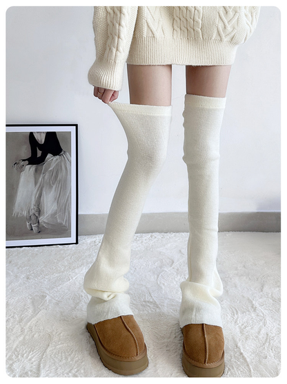 Cream ribbed over-the-knee leg warmers worn with one upper opening gently stretched