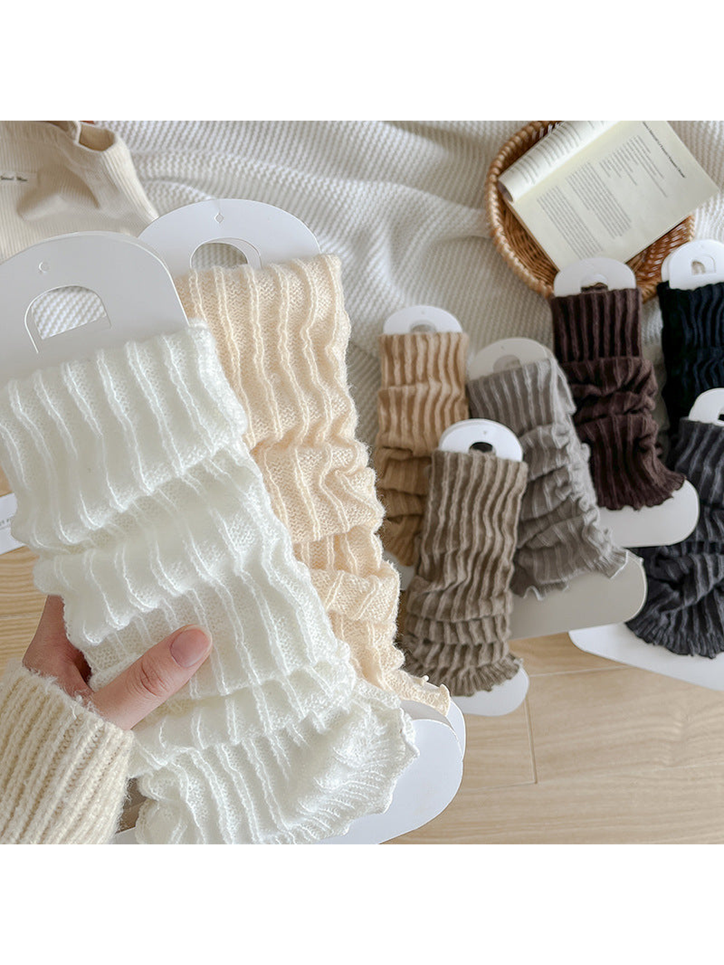 White and ivory ribbed ruffle-edge socks held in front of assorted colors