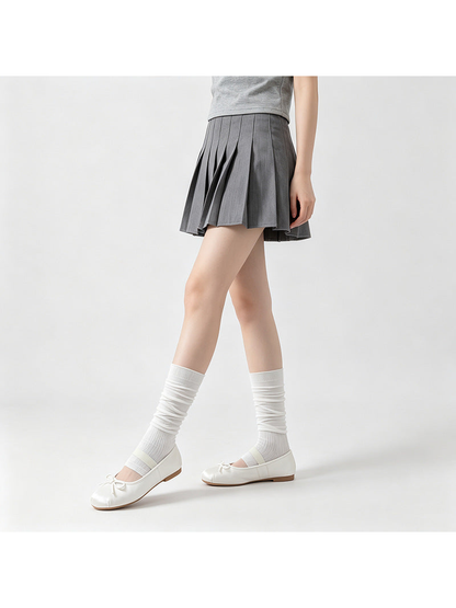 White ribbed open-toe mid-calf socks worn with ballet flats in a walking pose