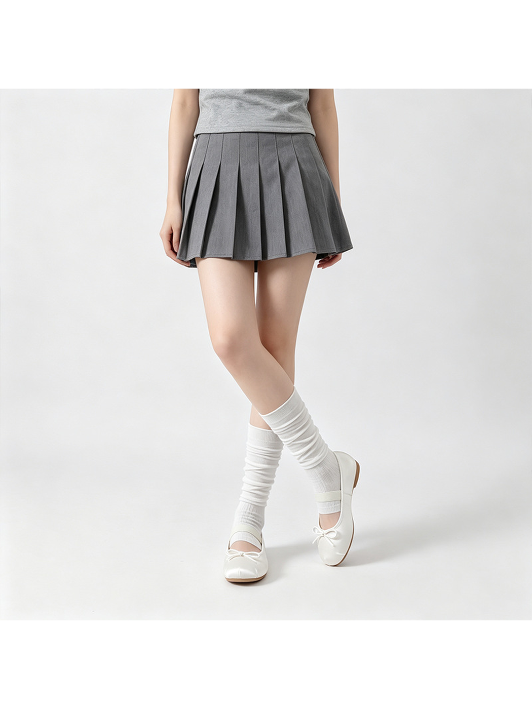 White ribbed open-toe mid-calf socks worn with ballet flats in a crossed-leg standing pose