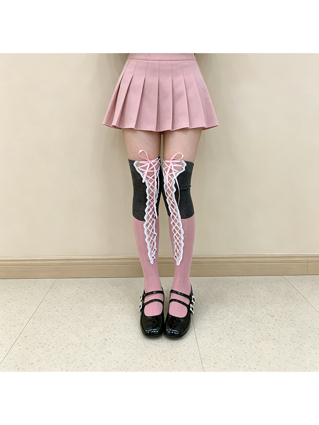 Gray / Pink over-the-knee socks with pink lacing, worn front view
