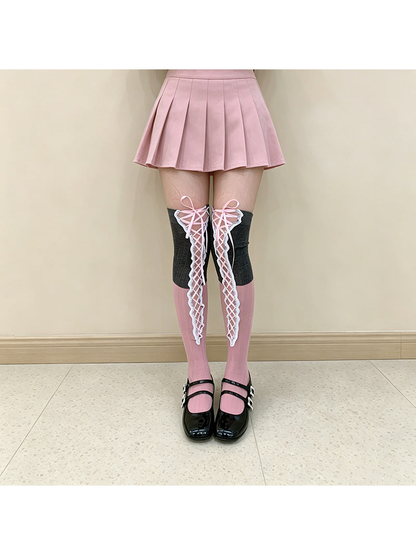 Gray / Pink over-the-knee socks with pink lacing, worn front view