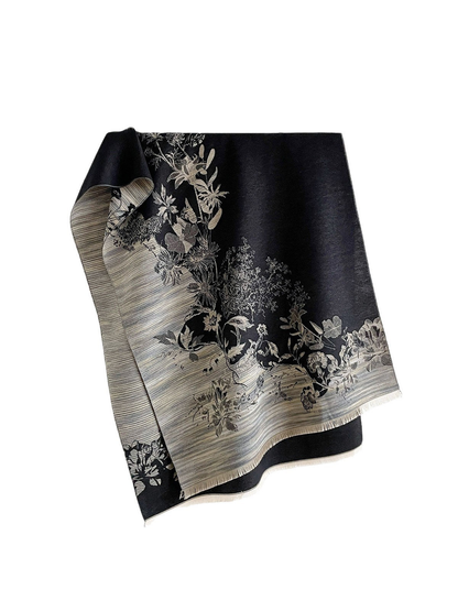 Black floral scarf with contrasting gray striped borders and short fringe, draped against a white background.