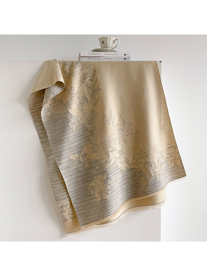Ivory floral scarf draped open with gray striped borders and short fringe.