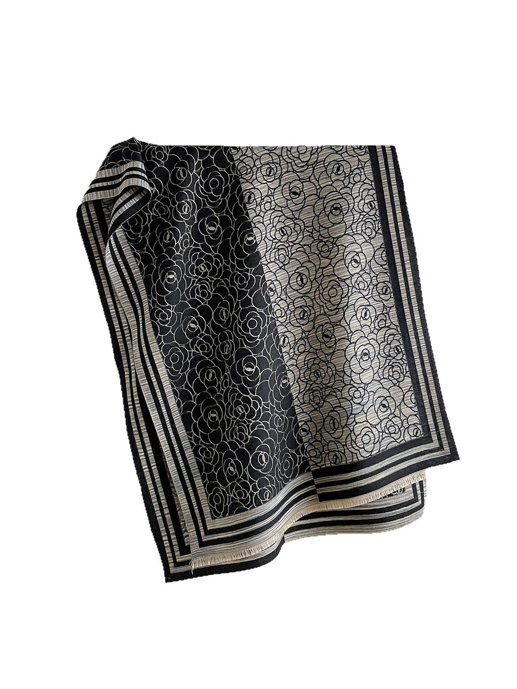 Black Gray floral scarf with contrasting panels, striped borders and short fringe, draped against white.