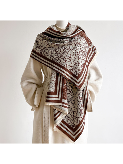 Brown / Ivory floral scarf spread across a mannequin's shoulders over a cream coat.