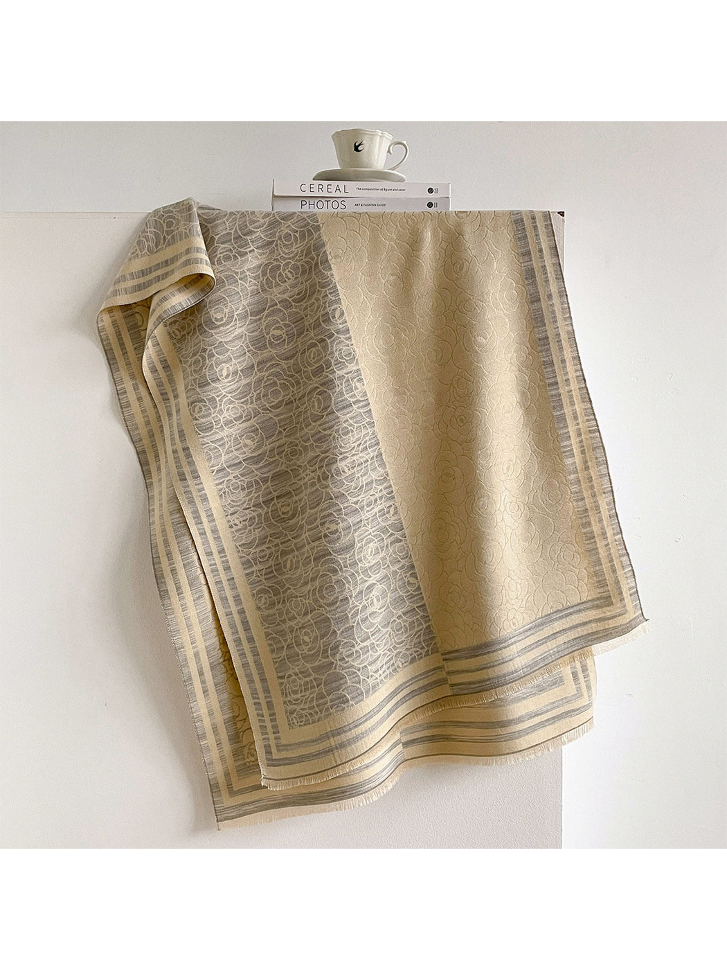 Gray / Cream floral scarf draped to show contrasting panels, striped borders and short fringe.