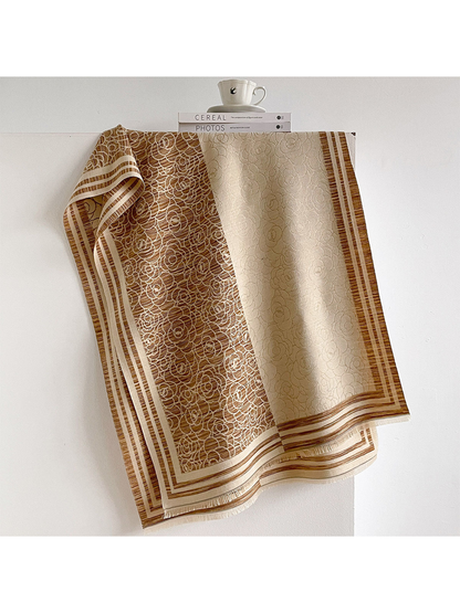 Camel / Cream floral scarf draped to show contrasting panels, striped borders and short fringe.