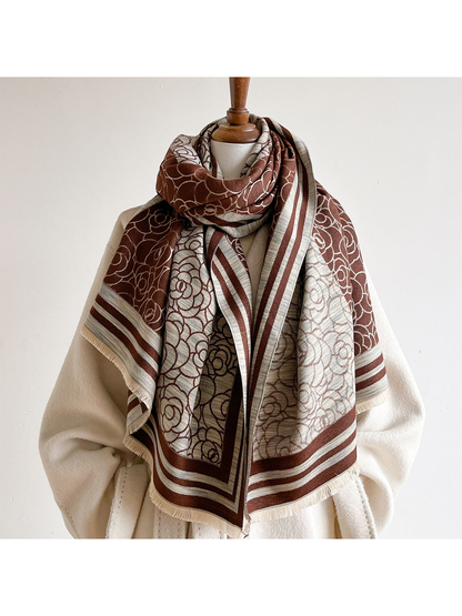 Brown / Ivory floral scarf looped around a mannequin's neck with both ends draped over a cream coat.
