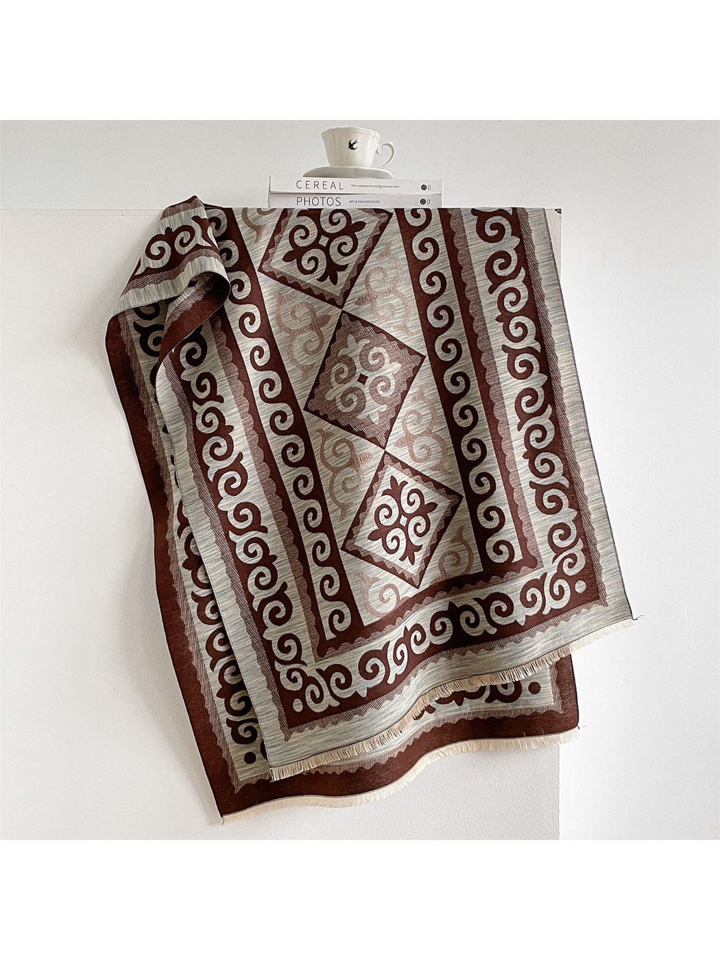 Coffee / Ivory scarf draped open with scroll borders, diamond medallions, and short fringe.