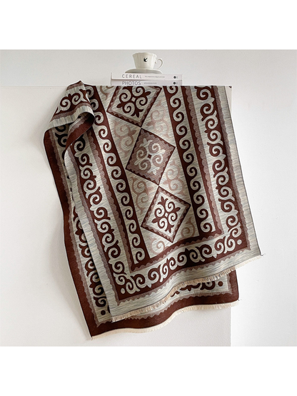 Coffee / Ivory scarf draped open with scroll borders, diamond medallions, and short fringe.