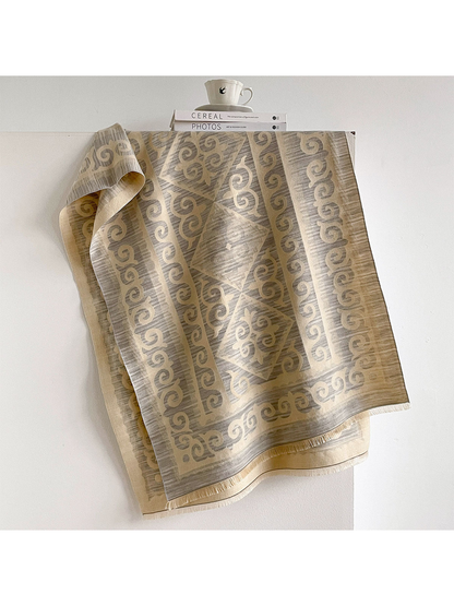Gray / Cream scarf draped open with scroll borders, diamond medallions, and short fringe.