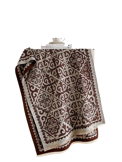 Brown ornamental scarf with geometric border and fringed ends