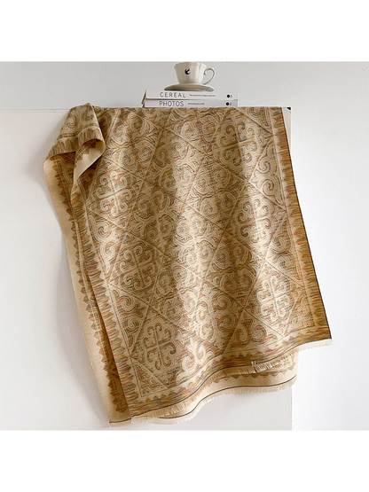 Khaki ornamental scarf with geometric border and fringed ends