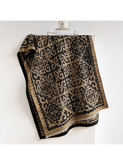 Gold ornamental scarf with dark geometric border and fringed ends